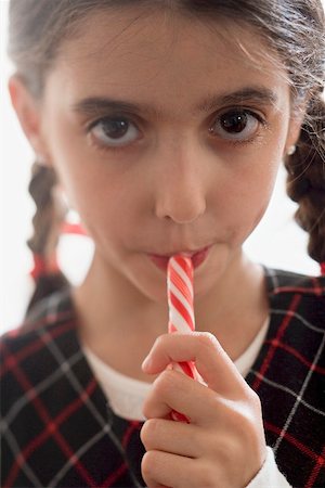 Girl eating candy stick Stock Photo - Premium Royalty-Free, Code: 659-02214230