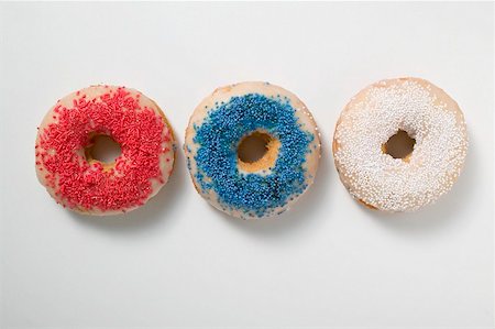 sprinkles - Three doughnuts with sprinkles (red, blue, white) Stock Photo - Premium Royalty-Free, Code: 659-02212105