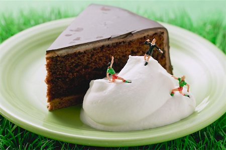 Piece of Sacher torte with cream and football figures Stock Photo - Premium Royalty-Free, Code: 659-02213099