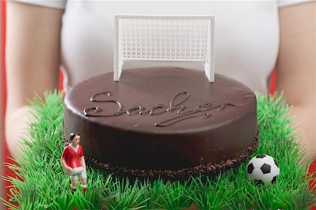 simsearch:659-02213122,k - Woman holding Sacher torte with football figure & football Stock Photo - Premium Royalty-Free, Code: 659-02213091
