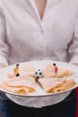 simsearch:659-02213122,k - Woman serving plate of sweet crêpes with football figures Stock Photo - Premium Royalty-Free, Code: 659-02213109