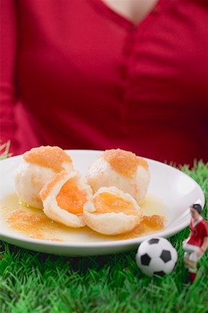 simsearch:659-01850806,k - Woman serving apricot dumplings with football figure & football Stock Photo - Premium Royalty-Free, Code: 659-02213114
