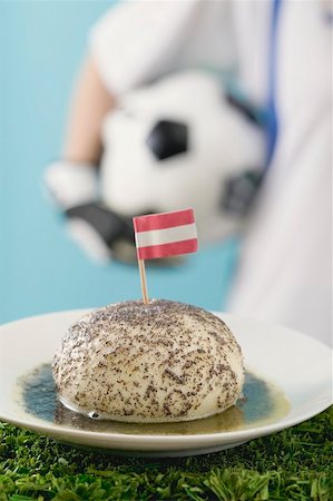 simsearch:659-02213122,k - Yeast dumpling with flag, footballer in background Stock Photo - Premium Royalty-Free, Code: 659-02213118