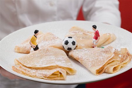 simsearch:659-02213122,k - Woman serving plate of sweet crêpes with football figures Stock Photo - Premium Royalty-Free, Code: 659-02213110