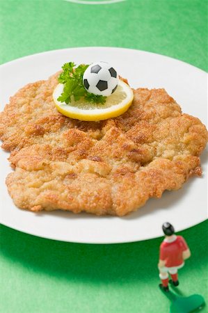 simsearch:659-02213122,k - Wiener schnitzel (veal escalope) with football figure & football Stock Photo - Premium Royalty-Free, Code: 659-02213126