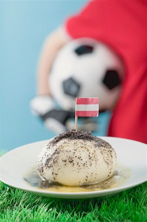 simsearch:659-02213122,k - Yeast dumpling with flag, footballer in background Stock Photo - Premium Royalty-Free, Code: 659-02213120