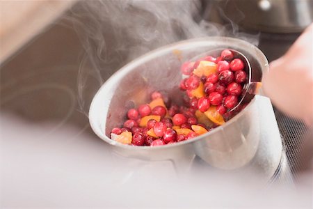 Making cranberry sauce: boiling cranberries and oranges Stock Photo - Premium Royalty-Free, Code: 659-02213954