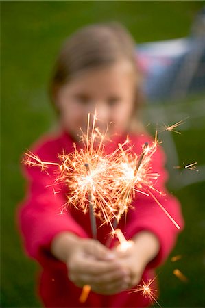 fourth of july - Small girl holding sparklers in garden Stock Photo - Premium Royalty-Free, Code: 659-03524442