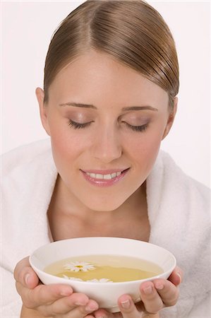 Woman with white towel and bowl of tea Stock Photo - Premium Royalty-Free, Code: 659-03524451