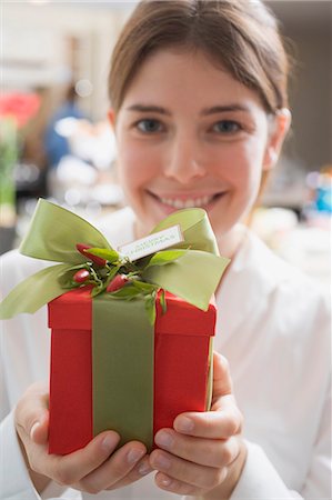 simsearch:659-03526649,k - Young woman holding Christmas gift Stock Photo - Premium Royalty-Free, Code: 659-03525120