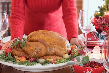 Woman serving roast turkey (Christmas) Stock Photo - Premium Royalty-Free, Code: 659-03525208