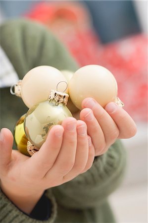Small boy holding Christmas baubles Stock Photo - Premium Royalty-Free, Code: 659-03525480