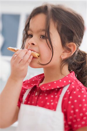 simsearch:659-03526649,k - Small girl eating home-made Christmas biscuit Stock Photo - Premium Royalty-Free, Code: 659-03525778