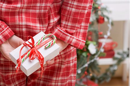simsearch:659-03526649,k - Woman hiding Christmas gift behind her back Stock Photo - Premium Royalty-Free, Code: 659-03525835