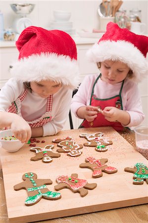 santa children - Two small girls decorating gingerbread men Stock Photo - Premium Royalty-Free, Code: 659-03526641