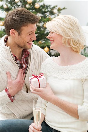 simsearch:659-03526649,k - Woman giving man Christmas gift Stock Photo - Premium Royalty-Free, Code: 659-03526663