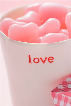 Pink heart-shaped sweets in beaker for Valentine's Day Stock Photo - Premium Royalty-Free, Code: 659-03527588