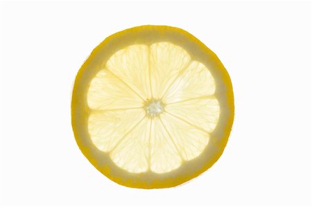 single lemon - A slice of lemon (backlit) Stock Photo - Premium Royalty-Free, Code: 659-03527694