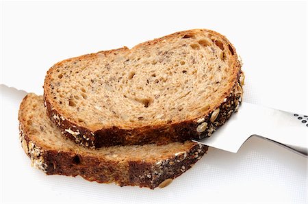 rye bread - Two slices of multigrain bread with bread knife Stock Photo - Premium Royalty-Free, Code: 659-03528199