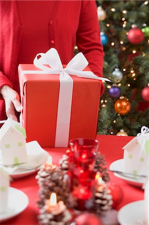 simsearch:659-03526649,k - Woman putting Christmas parcel on laid table Stock Photo - Premium Royalty-Free, Code: 659-03528322