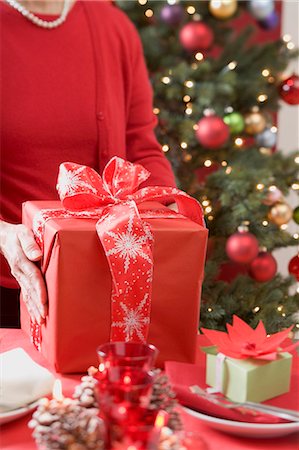 simsearch:659-03526649,k - Woman putting Christmas parcel on laid table Stock Photo - Premium Royalty-Free, Code: 659-03528323