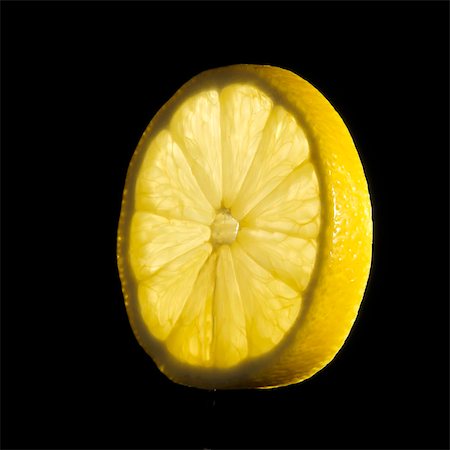 single lemon - A slice of lemon Stock Photo - Premium Royalty-Free, Code: 659-03528698