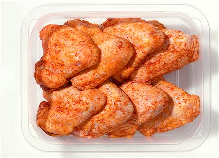 Spicy chicken wings in plastic container Stock Photo - Premium Royalty-Free, Code: 659-03528724