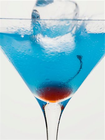 simsearch:659-01850296,k - Blue Curaçao cocktail with cocktail cherry & ice cube Stock Photo - Premium Royalty-Free, Code: 659-03528886