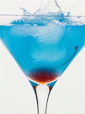 simsearch:659-01850296,k - Blue Curaçao cocktail with cocktail cherry and ice cube Stock Photo - Premium Royalty-Free, Code: 659-03528887