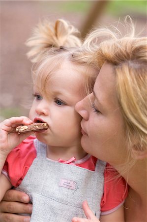 Little girl eating nut chocolate Stock Photo - Premium Royalty-Free, Code: 659-03529834