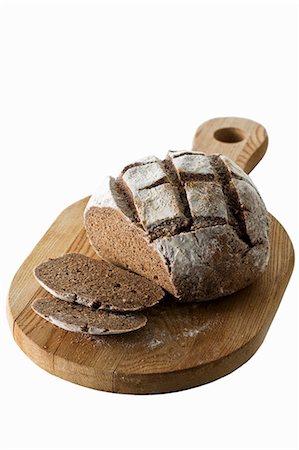 rye bread - Dark rye bread, partly sliced Stock Photo - Premium Royalty-Free, Code: 659-03529945