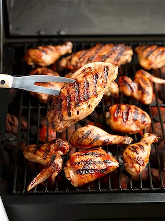 Chicken on the Grill; BBQ Fork Stock Photo - Premium Royalty-Free, Code: 659-03521355