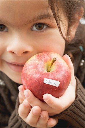 Girl with an organic apple Stock Photo - Premium Royalty-Free, Code: 659-03521666