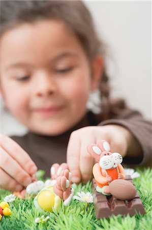 shape toys - A girl playing with chocolate figures Stock Photo - Premium Royalty-Free, Code: 659-03521759