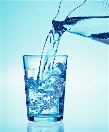 Pouring a glass of mineral water Stock Photo - Premium Royalty-Free, Code: 659-03522300