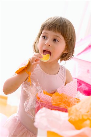 Little girl eating sweets Stock Photo - Premium Royalty-Free, Code: 659-03522622