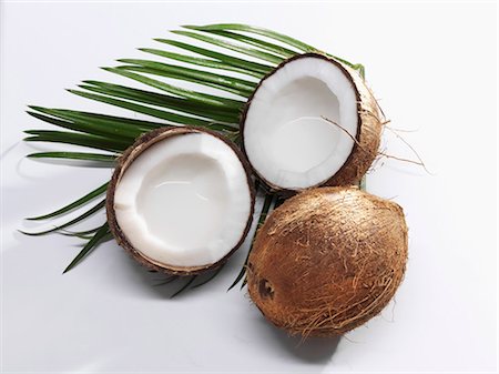 palm leaf - Coconuts, whole and halved, and palm leaf Stock Photo - Premium Royalty-Free, Code: 659-03522916