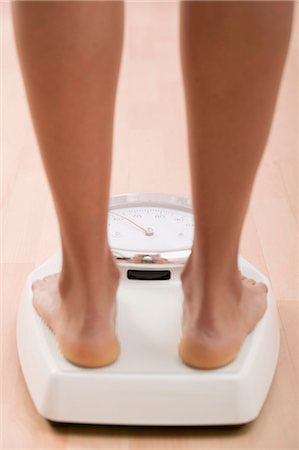 feet scale woman - Young woman on bathroom scales Stock Photo - Premium Royalty-Free, Code: 659-03523367