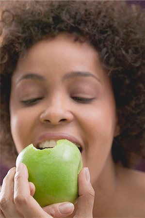 Young woman biting into an apple Stock Photo - Premium Royalty-Free, Code: 659-03523392