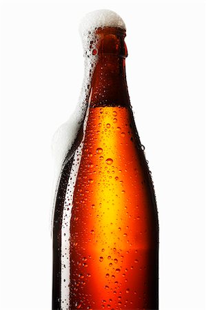 Beer frothing out of bottle Stock Photo - Premium Royalty-Free, Code: 659-03534058