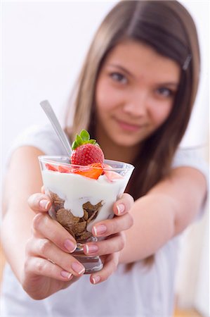 Girl holding yoghurt muesli with strawberries Stock Photo - Premium Royalty-Free, Code: 659-03534797