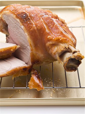 Roast pork on the bone with crackling, partly carved Stock Photo - Premium Royalty-Free, Code: 659-03535188