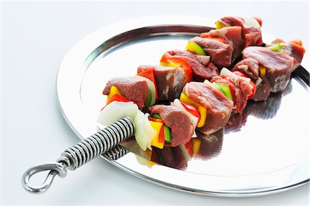 Two raw meat and vegetable kebabs Stock Photo - Premium Royalty-Free, Code: 659-03535778