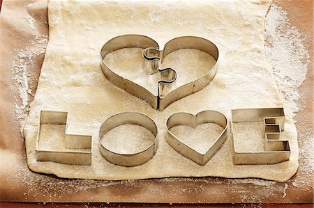 Biscuit cutters for 'LOVE' biscuits on dough Stock Photo - Premium Royalty-Free, Code: 659-03536701