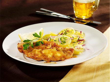 Wiener Schnitzel (breaded veal escalope) with potato salad Stock Photo - Premium Royalty-Free, Code: 659-03536776