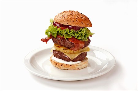 Double-decker burger with bacon and pineapple Stock Photo - Premium Royalty-Free, Code: 659-03537255