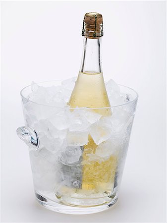 Bottle of sparkling wine in ice bucket Stock Photo - Premium Royalty-Free, Code: 659-03530748