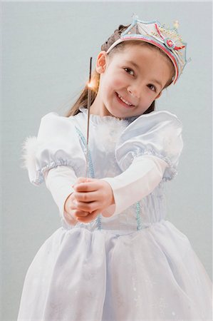 Little girl dressed as princess holding a sparkler Stock Photo - Premium Royalty-Free, Code: 659-03530975