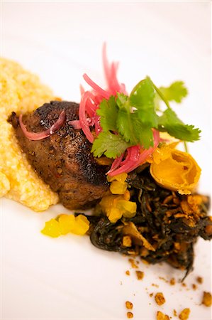 Maple Soaked Angus Beef Tenderloin on Jalapeno Grits and Greens Stock Photo - Premium Royalty-Free, Code: 659-03531786