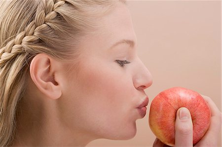 Woman kissing red apple Stock Photo - Premium Royalty-Free, Code: 659-03531973